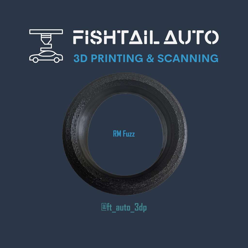 A circular black textured ring or tire-like object centered on a dark blue background, with the text 'FISHTAIL AUTO 3D PRINTING & SCANNING' at the top and 'RM Fuzz' plus '@ft_auto_3dp' on the object and below it.